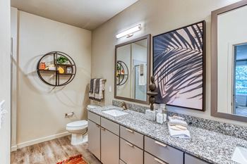 a bathroom with a sink and a toilet and a mirror at The Beck at Hidden River, Florida
